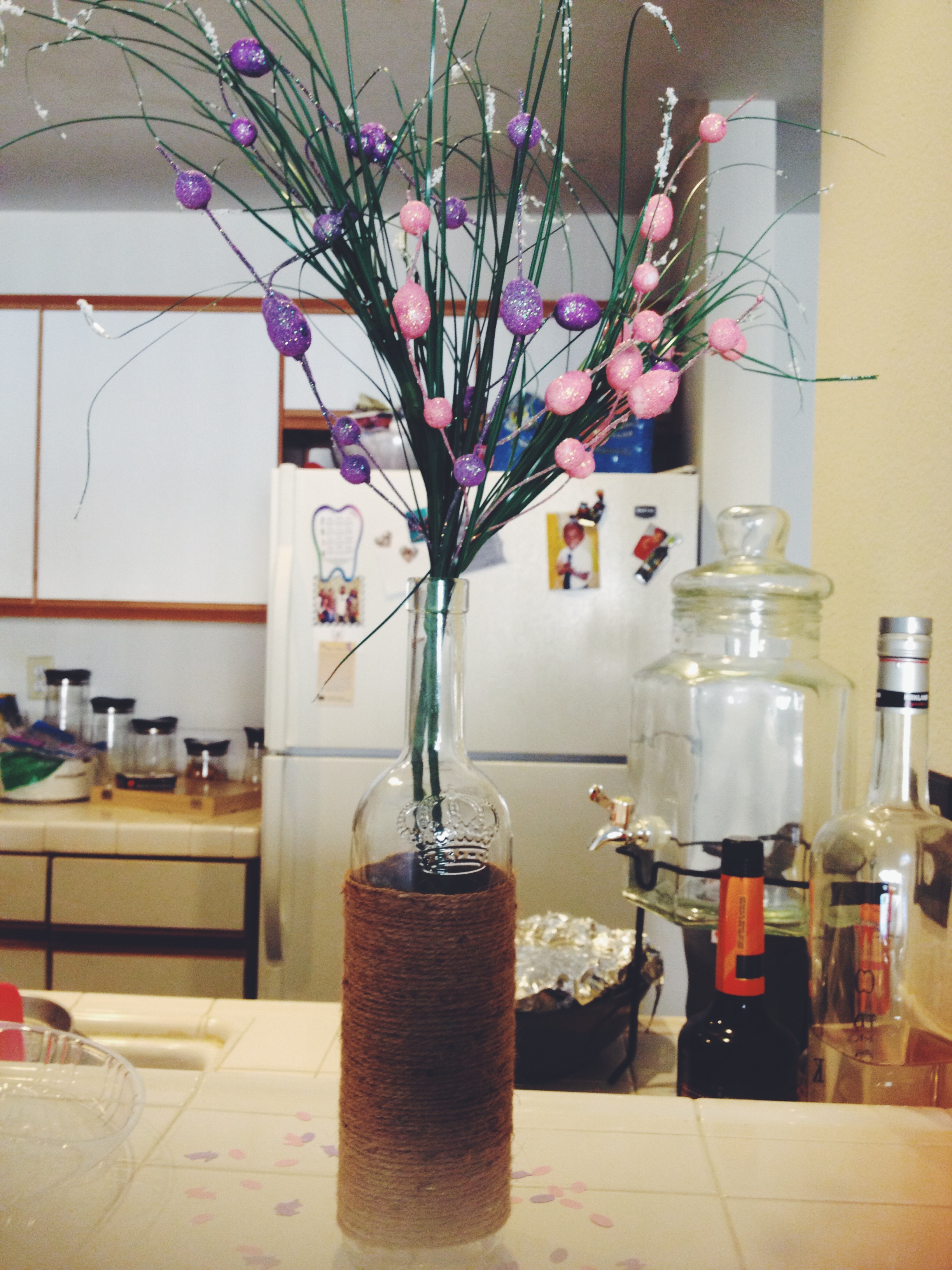 A cute DIY project using a wine bottle, twine and branches with spring bulbs